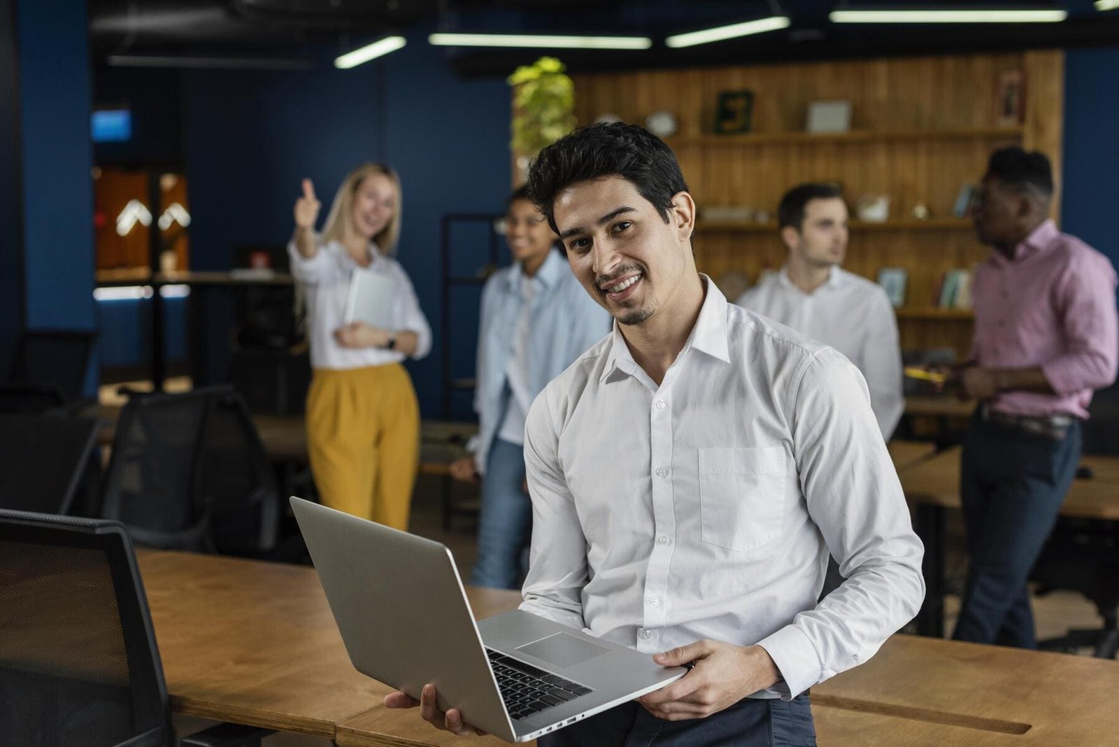 smiley-man-work-holding-laptop-posing